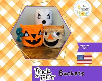 May include: Three crocheted Halloween buckets: an orange pumpkin, a beige scarecrow, and a white ghost. The pumpkin has a black face and teal accents. The scarecrow has a beige face and a black smile. The ghost has black eyes and mouth. The text "Trick or Treat Buckets" is visible.