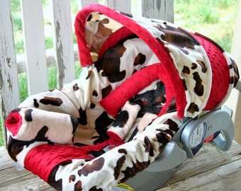 baby car seat cover and hood cover in Brown cow print with red minky head pillow headrest strap covers handle cushion