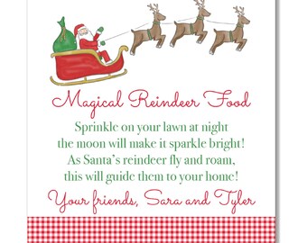 May include: Square card featuring a watercolour illustration of Santa in a red sleigh with three reindeer. The text reads "Magical Reindeer Food" and a poem. A red and white checked border is at the bottom.