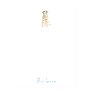 May include: A white stationery card featuring a watercolor illustration of a yellow Labrador Retriever wearing a light blue bow tie. The text "The Lanes" is written in a light blue script at the bottom of the card.
