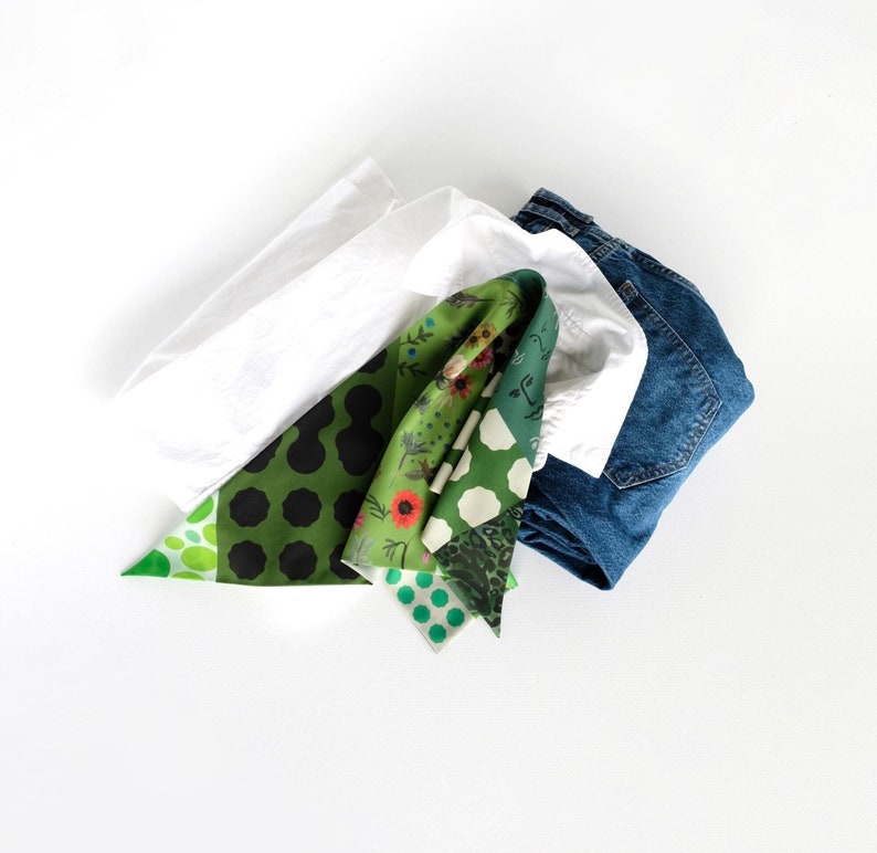 Green patchwork print small triangle scarf photographed with a white shirt and a pair of jeans.