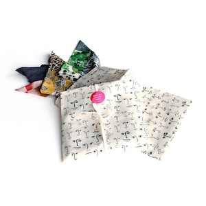 Photograph of our reusable cotton face print handmade cotton pouch that scarves are delivered in.