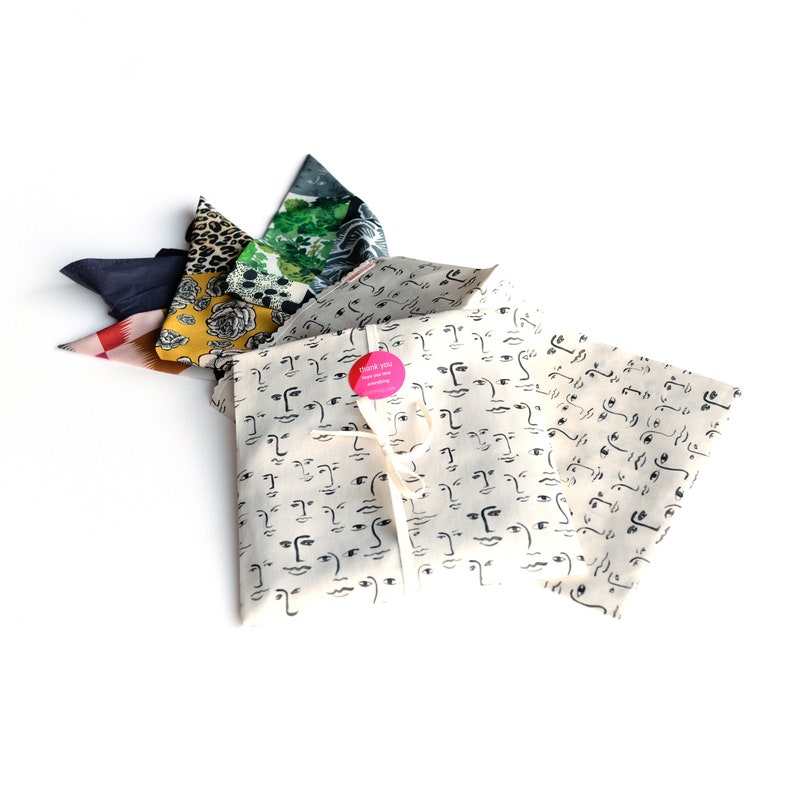 Photograph of our reusable cotton face print handmade cotton pouch that scarves are delivered in.