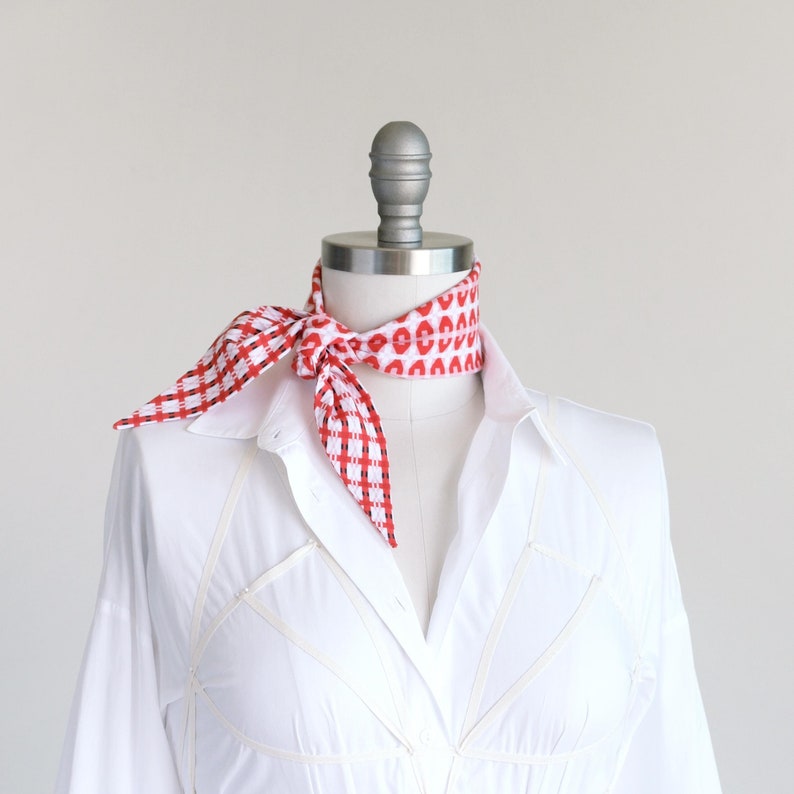Seersucker cotton red plaid skinny diamond scarf shown tied as a neckerchief on a mannequin in a white blouse.