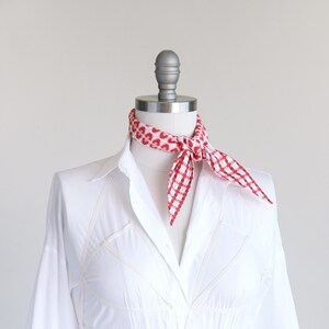 Seersucker cotton red plaid skinny diamond scarf shown tied as a neckerchief on a mannequin in a white blouse.