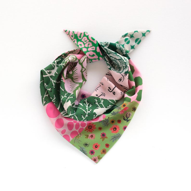 May include: A colorful square scarf with a variety of patterns. The scarf features sections of pink polka dots, green floral designs, and green and pink abstract patterns. The scarf is tied at the top.