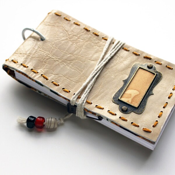 Paper refillable pocket flip leather notebook with an antique gold name tag