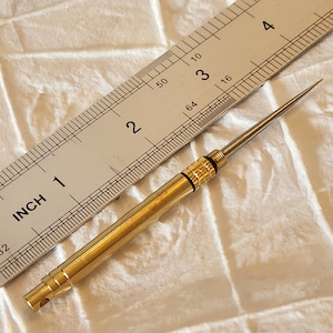 Bookbinding travel brass punch  awl. Collapsible with a fine tip.