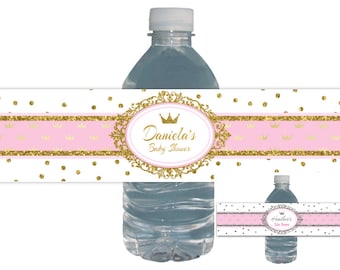 May include: Water bottle label with a pink and gold glitter design. The label says "Daniela's Baby Shower" with a gold crown.