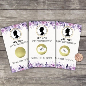 May include: Three scratch-off cards with a floral design and the text "ARE YOU LADY WHISTLEDOWN?" Each card has a gold circle to scratch off, revealing "YES" or "NO". A penny is next to the cards.