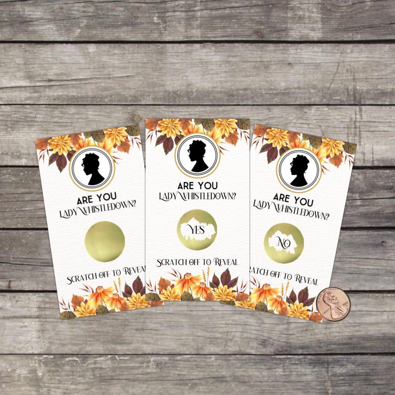 May include: Three scratch-off cards with the text "ARE YOU LADY WHISTLEDOWN?" and a silhouette. One card says "YES", another says "NO". The cards have a floral design and are on a wooden surface.