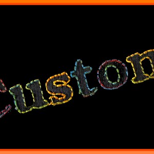 May include: The word "Custom" is embroidered in black thread on a black background. The letters are outlined in yellow, red, blue, and green thread.