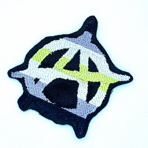 May include: Embroidered patch with the anarchy symbol, a capital "A" within a circle. The patch has a black border, with the symbol in white, grey, and light green. The patch is diamond-shaped with rounded edges.