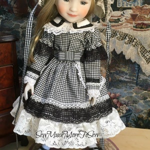 May include: A porcelain doll wearing a black and white gingham dress with lace trim and a white bonnet. The doll is holding a small black and brown dachshund figurine.