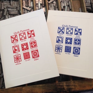 May include: Two cards with the title "Quilt Patterns" printed on them. The cards feature nine different quilt block patterns with their names printed below each block. The patterns on the left card are printed in red and the patterns on the right card are printed in blue.