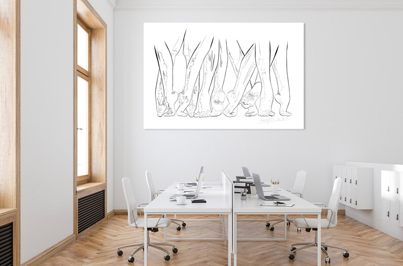 May include: A large, rectangular black and white line art print depicting multiple pairs of feet and legs. The artwork is mounted on a white wall above a series of white desks with laptops and chairs. The room has a window with a wooden frame.
