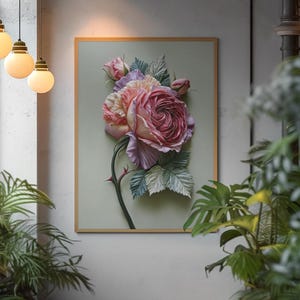 May include: A framed floral art piece featuring a large, detailed rose in shades of pink and red, with green leaves and a thorny stem. The artwork is set against a light green background within a wooden frame, creating a three-dimensional effect.