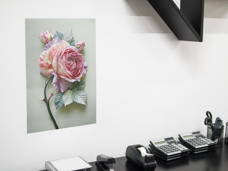 May include: A floral print on a rectangular canvas. The artwork features a large, detailed rose in shades of pink and peach, with green and blue-grey leaves. The rose is the focal point, with a dark green stem and thorns.