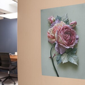 May include: A framed floral art print featuring a large, detailed rose in shades of pink, lavender, and cream. The rose is the focal point, with green leaves and a thorny stem against a pale green background. The artwork is mounted on a wall.