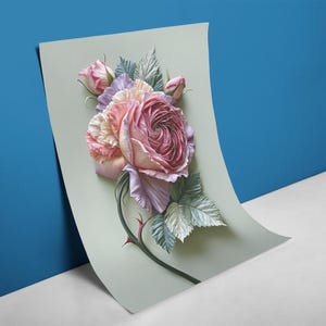 May include: A floral art print featuring a large, detailed rose in shades of pink, lavender, and cream, with green leaves and a thorny stem. The artwork is displayed on a light green paper against a blue and white background.