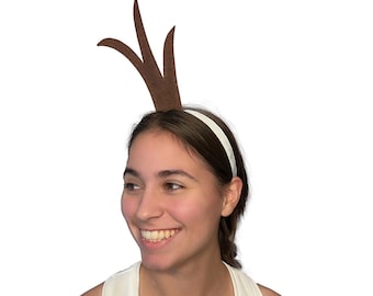 May include: A white headband with brown felt antlers attached. The headband is worn by a person with brown hair.