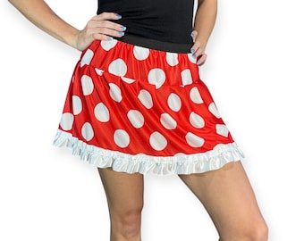 May include: A red and white polka dot skirt with a white ruffle trim. The skirt is made of a soft, stretchy fabric and is perfect for a costume or party.