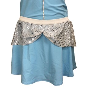 May include: A light blue dress with a silver sequin trim. The dress has a fitted bodice and a full skirt.