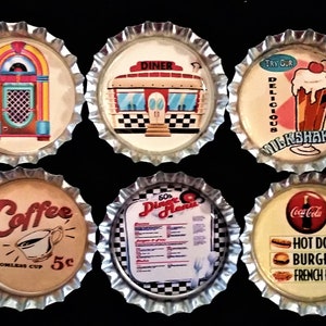 May include: A collection of six vintage-style bottle caps. Each cap features a different retro diner theme, including a jukebox, diner, milkshake, coffee cup, diner menu, and Coca-Cola with hot dogs, burgers, and fries.