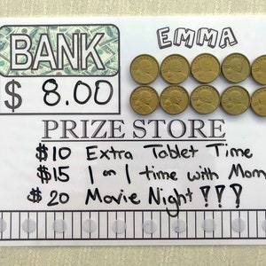 May include: A white board with black marker writing that says "BANK $8.00" and "PRIZE STORE" with a list of prizes: "$10 Extra Tablet Time", "$15 1 on 1 time with Mom", and "$20 Movie Night?!?" There are 10 gold coins with the word "LIBERTY" on them and the name "EMMA" written at the top of the board.
