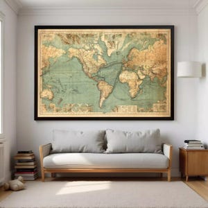 May include: A large rectangular wall art piece featuring a vintage-style world map with a muted color palette of tan landmasses and sage green oceans, enclosed in a thin black frame, displaying intricate cartographic details and shipping routes.
