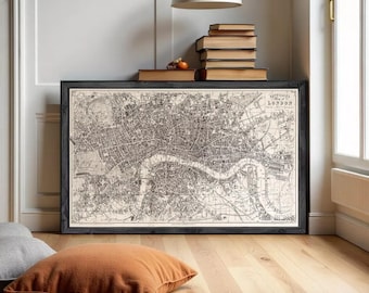 May include: A framed black and white vintage map of London featuring intricate street details and the River Thames, displayed in a dark wooden frame. The map includes the text "Reynolds's Map of London" in the upper right corner.