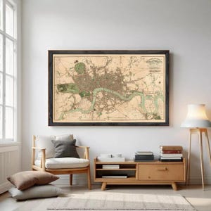 The image is a framed map of London, England, depicting the city's streets, landmarks, and surrounding areas.