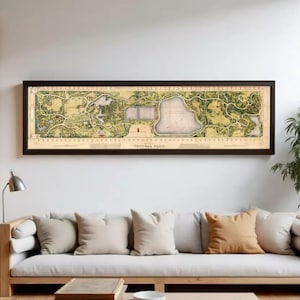 Op de afbeelding: Een ingelijste kaart van Central Park, New York City, in een rechthoekig, horizontaal formaat. De kaart toont een gedetailleerde illustratie van de indeling van het park, inclusief de paden, wateren en omliggende gebieden. De lijst is donkerbruin.