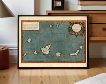 May include: A framed vintage-style map of the Canary Islands featuring a muted blue-green ocean background, detailed landmass illustrations, and decorative cartographic elements. The text includes the title Les Isles Canaries and descriptive French text blocks within a red and gold border.
