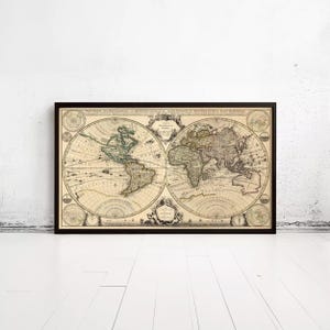 May include: A framed vintage-style world map print featuring two circular hemispheres in a beige tone with black ink details. The map displays continents, latitude and longitude lines, and decorative cartographic elements with text in French.