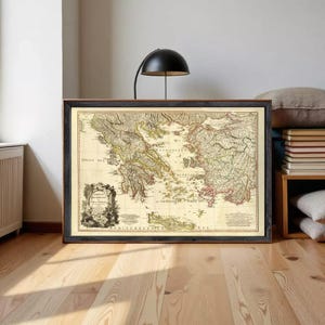 May include: A framed vintage-style map of Greece and the Aegean Sea featuring detailed topography, coastlines, and islands. The map includes an ornate cartouche in the lower left corner with the text GREECE ARCHIPELAGO AND PART OF ANATOLIA.