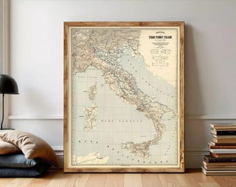 May include: A framed vintage map of Italy titled Strade Ferrate Italiane, featuring detailed railway lines, geographical terrain, and nautical labels across the Mediterranean, Tyrrhenian, and Adriatic seas in a light beige and brown color palette.