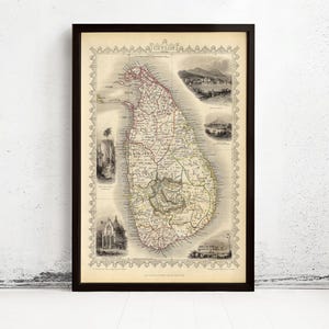 May include: Framed vintage map of Ceylon, now Sri Lanka, with detailed illustrations. The map shows the island's geography, roads, and towns, framed in a black wooden frame. The map is a historical piece, with measurements in centimetres.