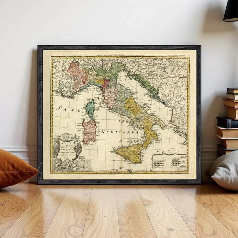 The image is a framed vintage map of Italy, showing the country's geographical layout and surrounding regions.