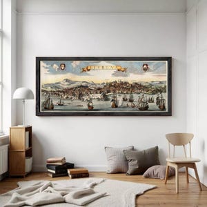 May include: A panoramic framed print depicting a historical map of Lisbon, featuring a coastal city landscape with numerous sailing ships on the water, mountains in the background, and a central banner with the text LISBONA in a dark wood frame.