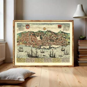May include: A framed vintage map print depicting a detailed city plan with buildings, streets, and ships on the water. The map is in shades of brown, green, and blue, with decorative elements and text. The frame is made of wood.