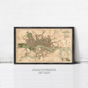 The image is a framed vintage map of London, England, depicting the city's streets, landmarks, and surrounding areas.