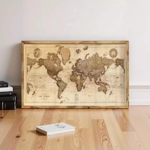May include: A rectangular framed wall art piece featuring a sepia-toned vintage world map. The map displays continents and oceans with intricate geographical details and the text "A CHART OF THE WORLD" printed in the lower left corner.