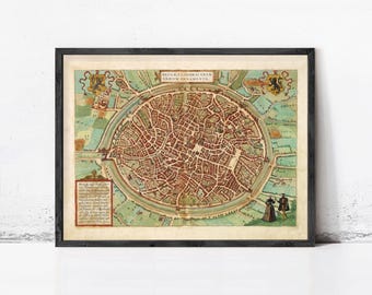 May include: A framed historical map of Bruges, Belgium, featuring a circular city layout with red-roofed buildings, green fields, and water canals. The map includes Latin text, heraldic crests, and two figures in the lower right corner.
