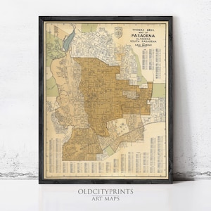May include: Framed vintage map of Pasadena, Altadena, South Pasadena, and San Marino, California. The map is in shades of tan, green, and blue, with a black frame. The text "Thomas Bros. Map of Pasadena" is visible.