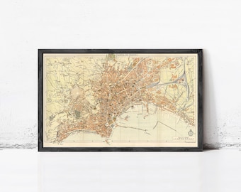 May include: Framed vintage map of Naples, Italy, in a black frame. The map features detailed city streets, buildings, and the coastline in shades of brown and beige. The text "PIANTA DI NAPOLI" is visible at the top.