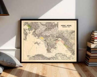 May include: A framed vintage map of Hong Kong, dated February 1941. The map features detailed topographical lines, with areas highlighted in yellow, green, and pink. The map is set against a cream-colored background and framed in black.