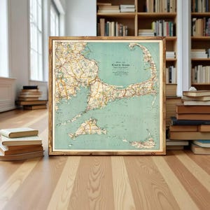 May include: A framed vintage map of Cape Cod and Vicinity with a light green ocean background, yellow landmasses, and detailed road networks. The text reads Map of Cape Cod and Vicinity, Published by George H. Walker and Co. Boston, Mass.