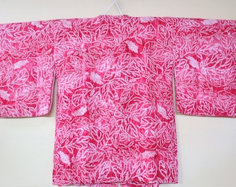 May include: A vibrant pink kimono-style garment with a white leaf pattern. The long-sleeved robe is displayed flat, showcasing the all-over design. The fabric appears soft and lightweight, suitable for layering or warmer weather.