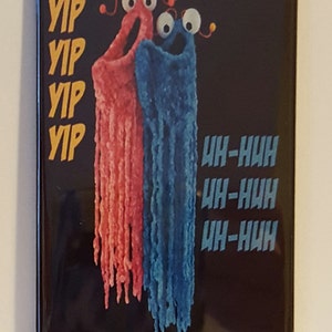 May include: A black background with two fuzzy, colorful characters. The character on the left is red and says "Yip" four times. The character on the right is blue and says "Uh-huh" three times.